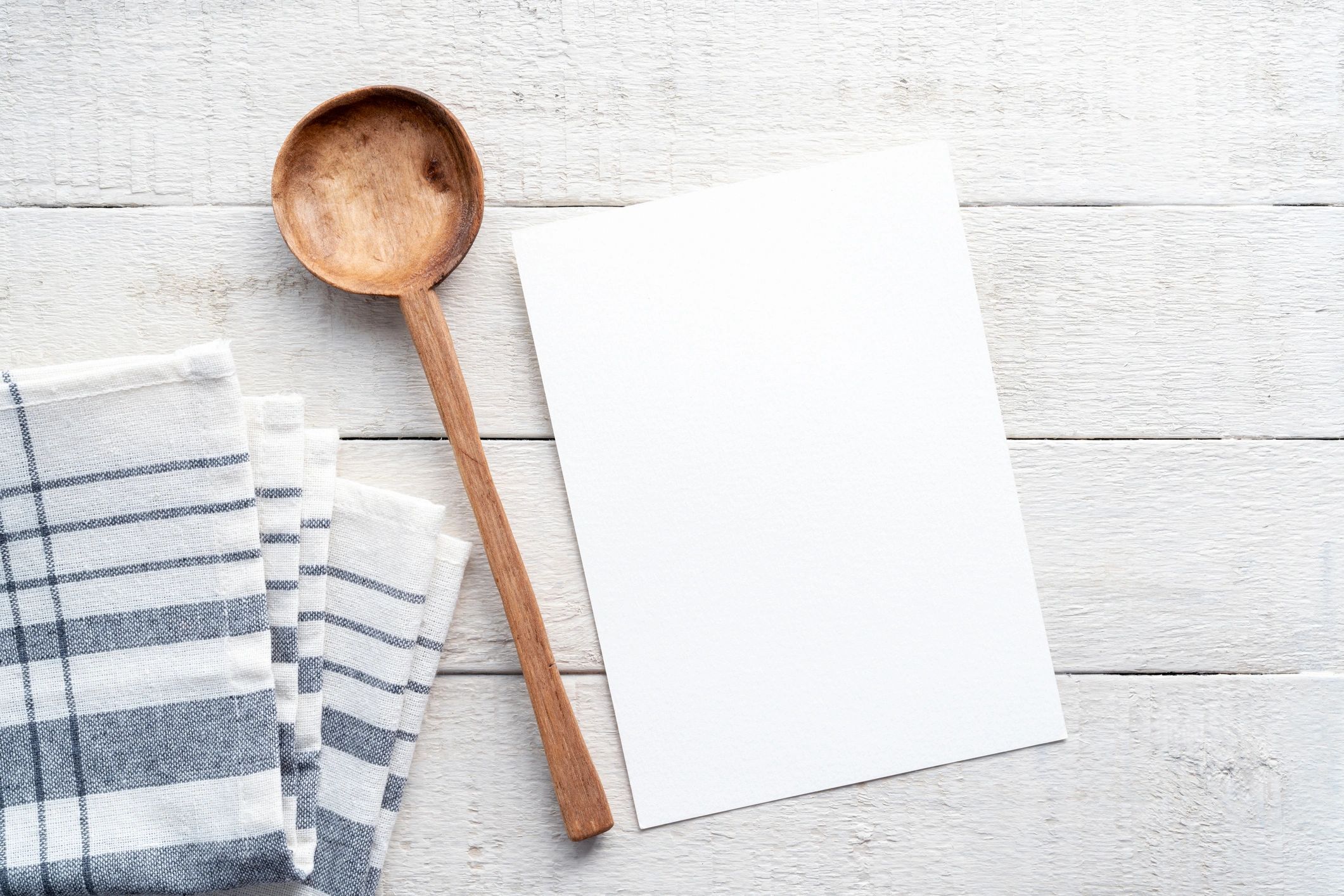 Blank recipe card mockup on white wooden table