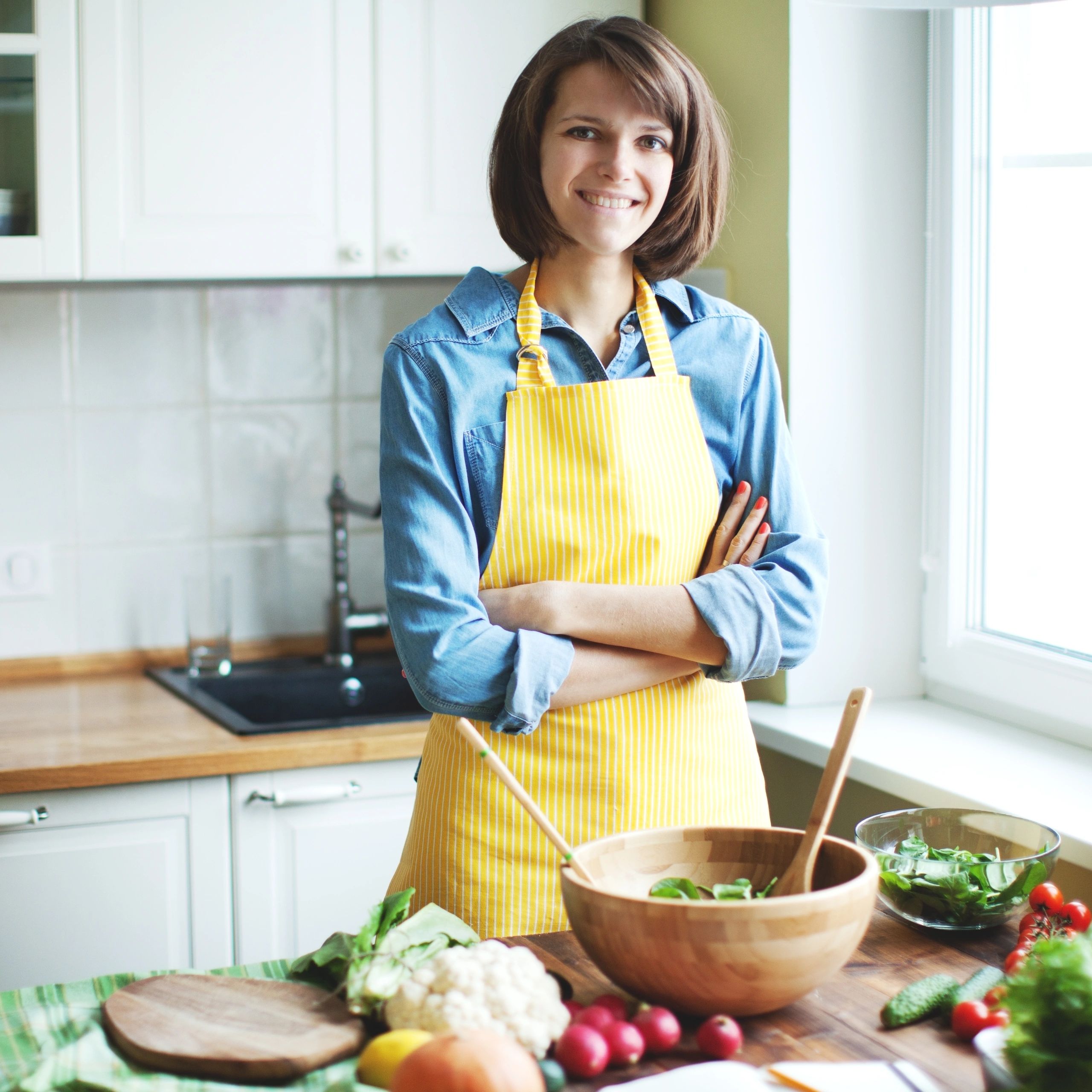 Smiling home cook preparing fresh vegetables